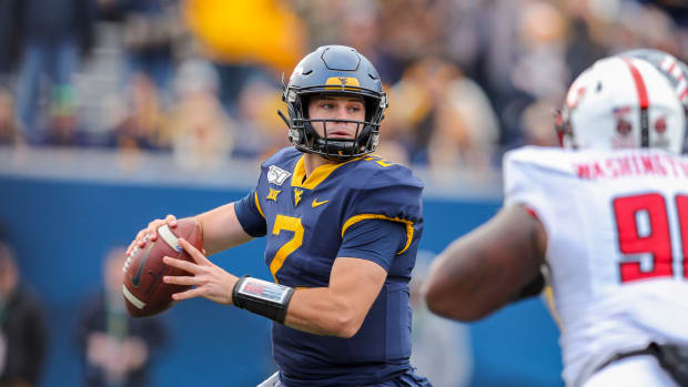 West Virginia Mountaineers quarterback Jarret Doege (2) throws a pass during the third quarter against the Texas Tech Red Raiders at Mountaineer Field at Milan Puskar Stadium.